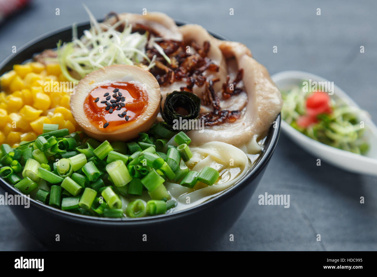 tonkotsu ramen, japanese noodle soup with pork belly, corn, spring