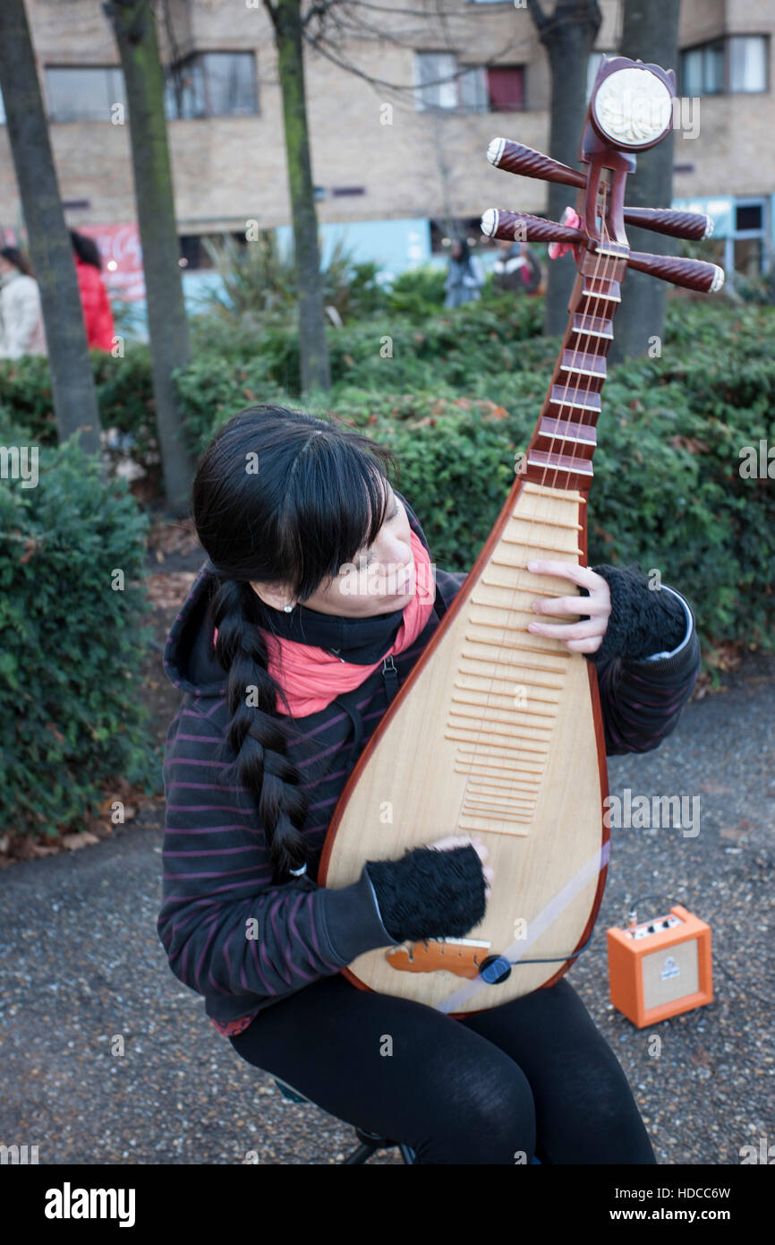 Girl busker playing Japanese musical instrument Stock Photo - Alamy