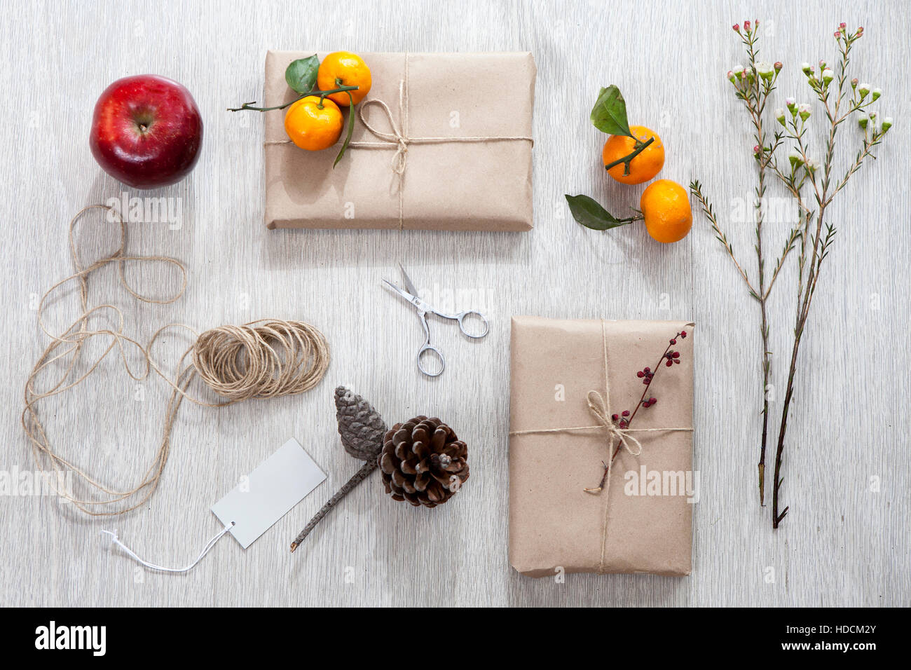 Various items for gift wrapping are on the table. Gifts already packed
