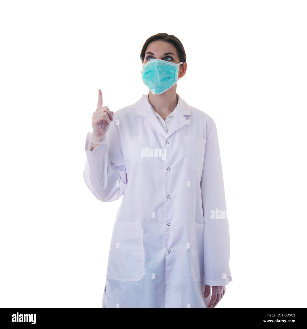 Female doctor in white coat over white isolated background in surgical mask pointing up, healthcare, profession and medicine concept Stock Photo