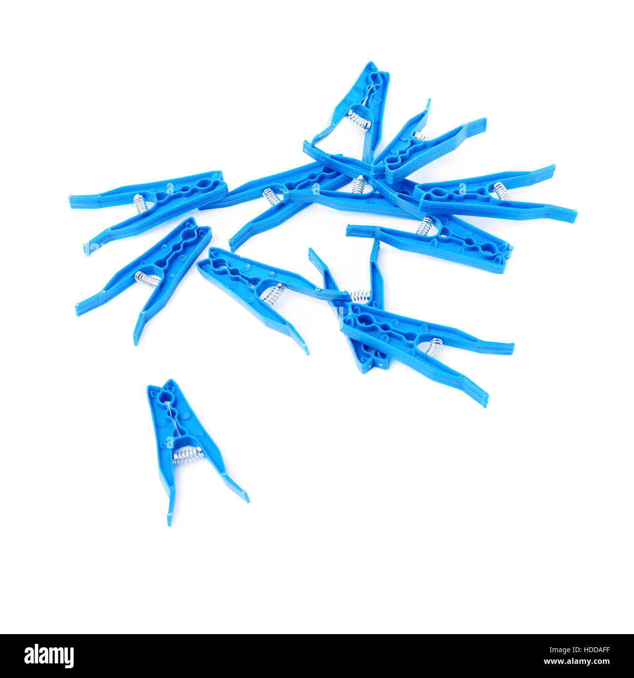Pile of blue plastic cloth pegs isolated over white background Stock Photo