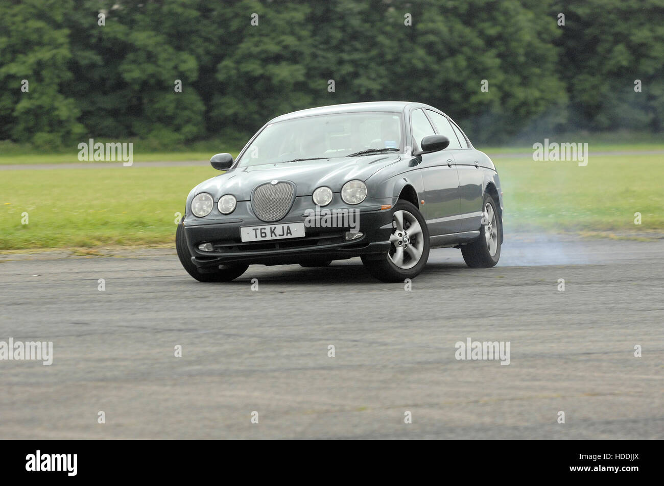 Jaguar S-type car smoking tyres and drifting Stock Photo