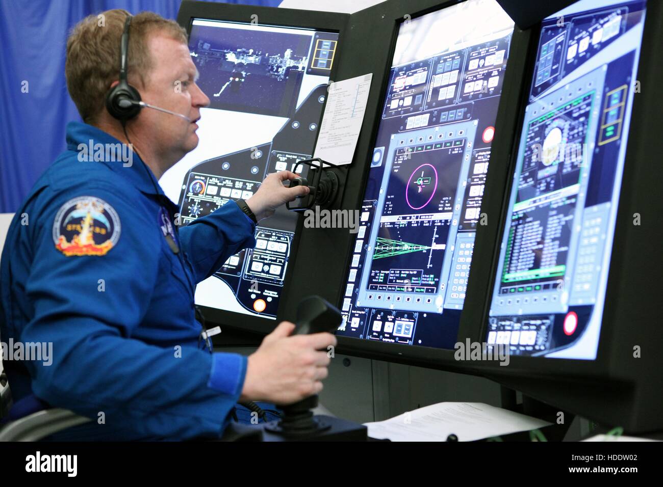 NASA astronaut Eric Boe runs mission scenarios in a Boeing part-task trainer that simulates spacecraft missions at the Boeing facility April 26, 2016 in St. Louis, Missouri. Stock Photo