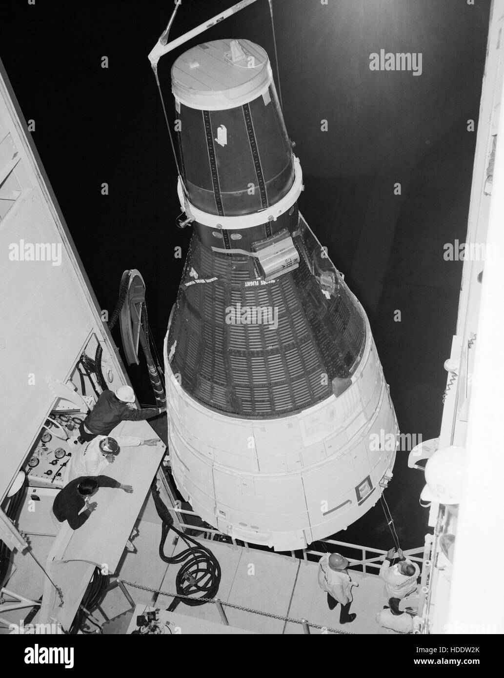 The NASA Gemini-3 spacecraft is hoisted above the Titan launch vehicle before their mating at the Cape Canaveral Air Force Station Launch Complex 19 March 17, 1965 in Cape Canaveral, Florida. Stock Photo