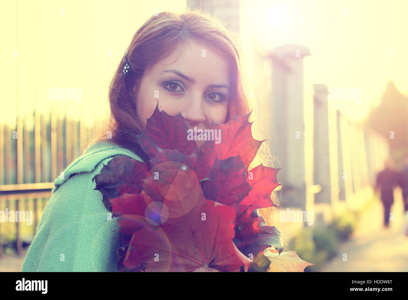 pretty young woman posing on camera in autumn park Stock Photo - Alamy