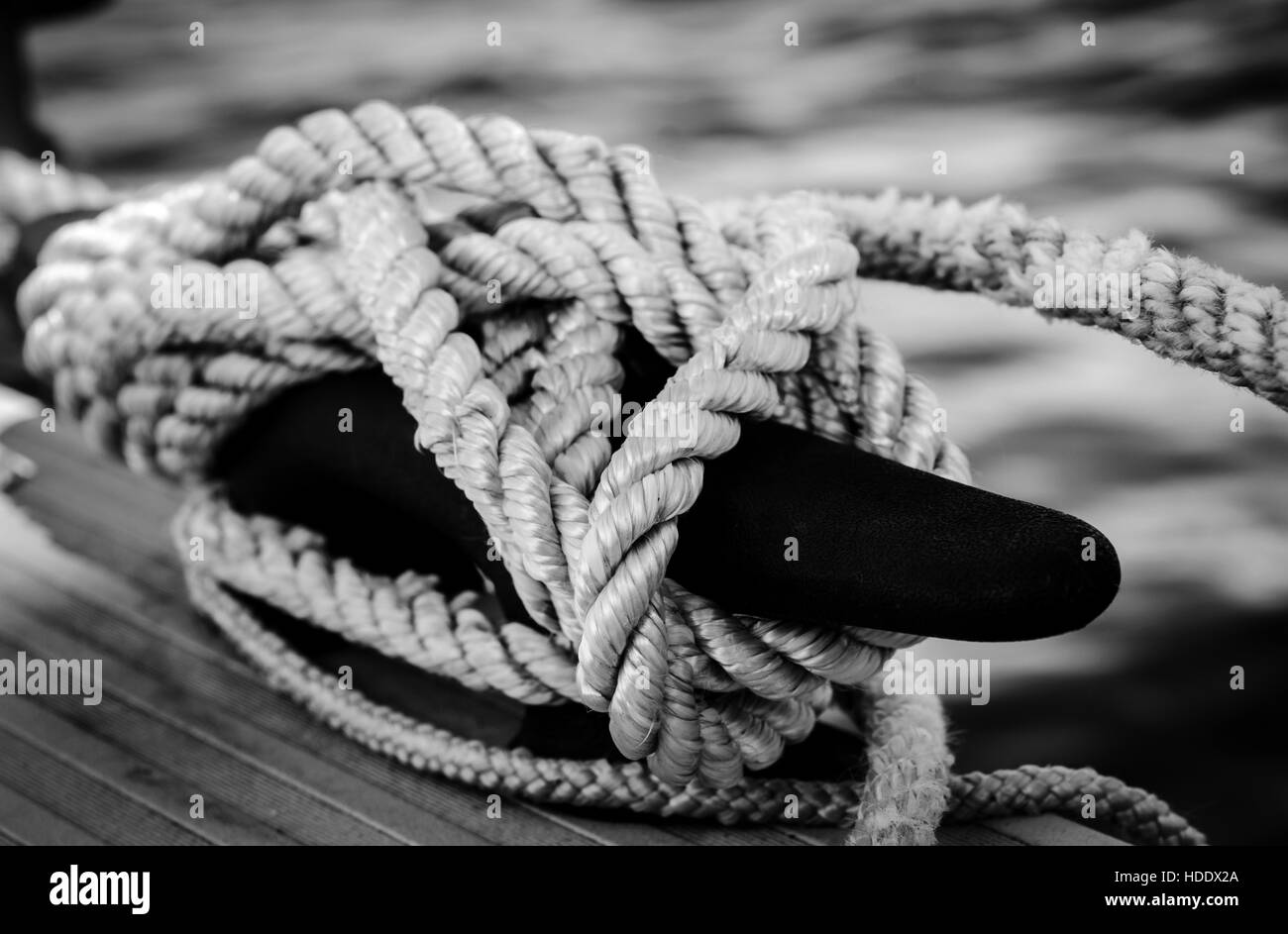 Rope tied around a cleat on a dock Stock Photo