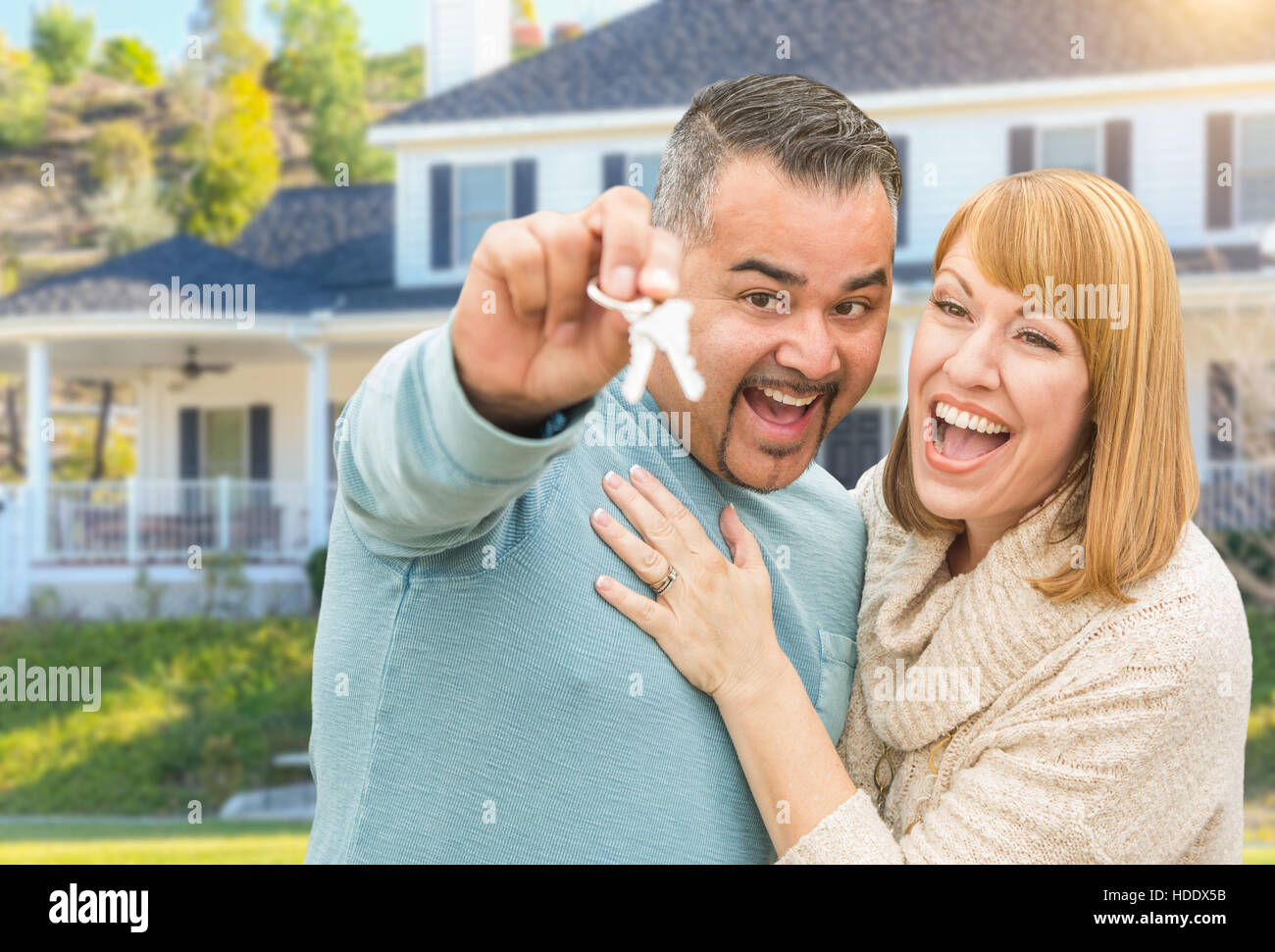 Happy Mixed Race Couple in Front of New Home with House Keys Stock ...