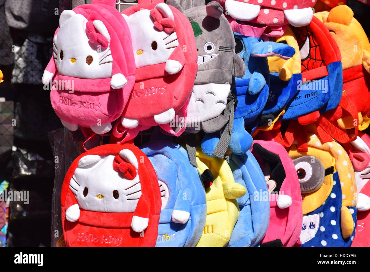 Small backpacks with Hello Kitty and other characters in a market stall