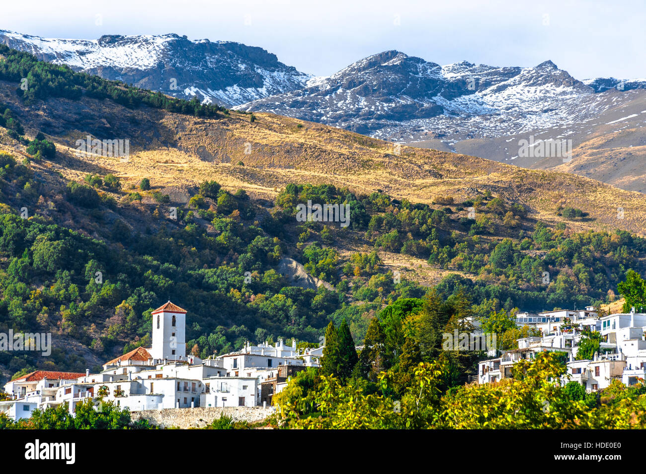 white village Capileira in the Alpujarra  and the peak of Mountain Mulhacén, Andalusia, Spain Stock Photo
