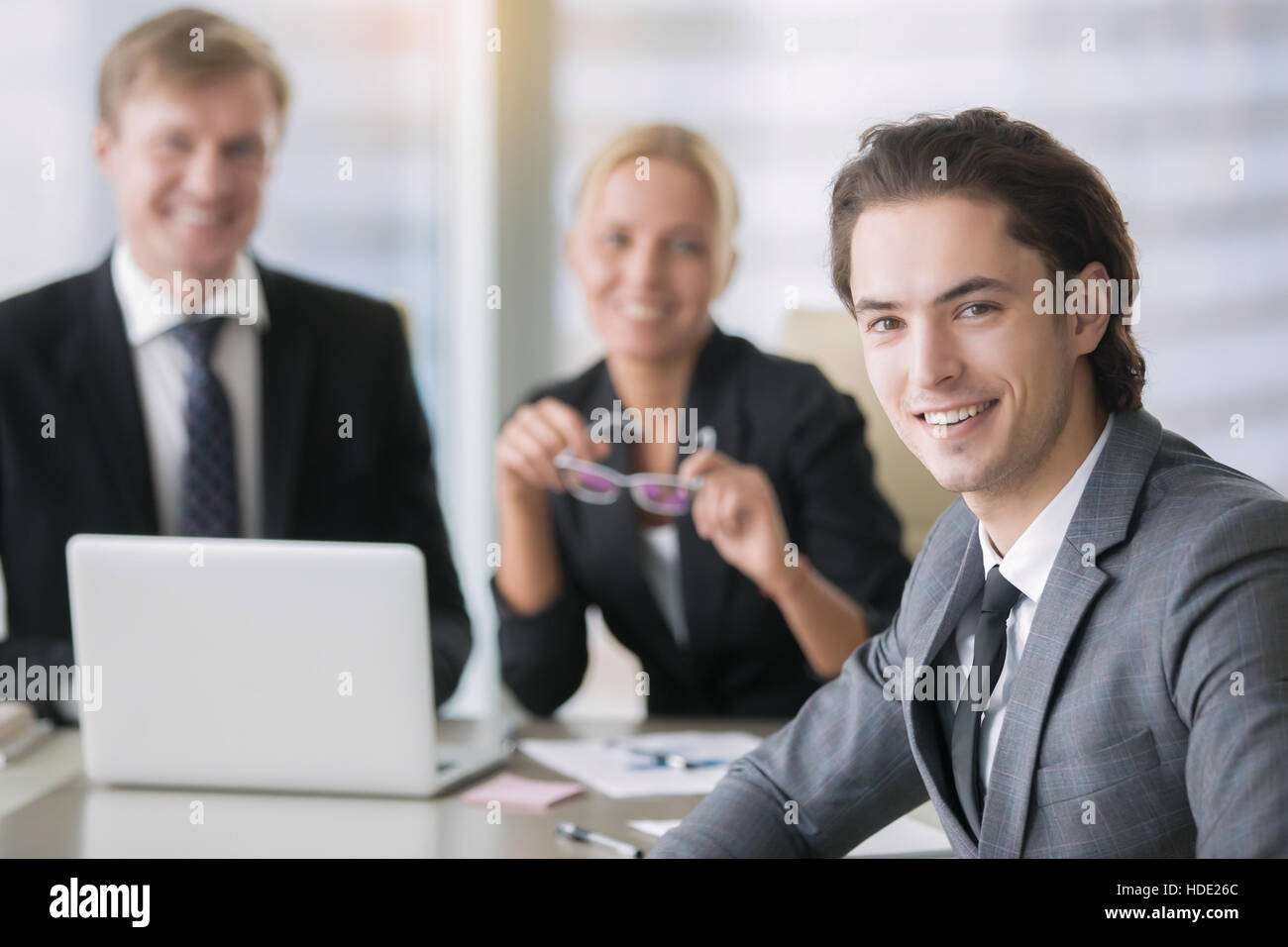 Group of business people and a smiling young man Stock Photo
