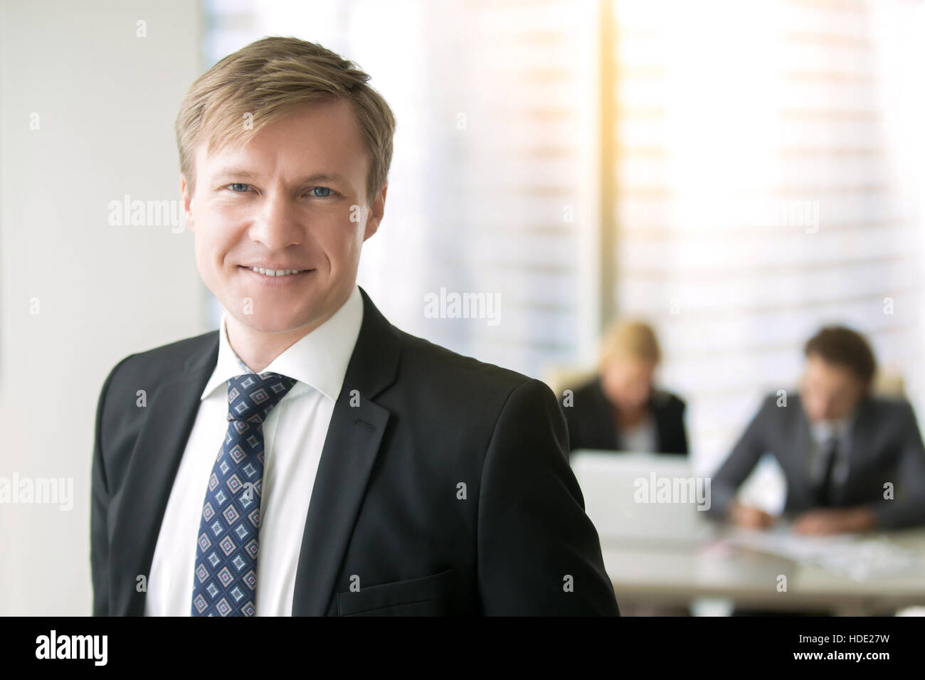 Portrait of a young smiling businessman Stock Photo - Alamy