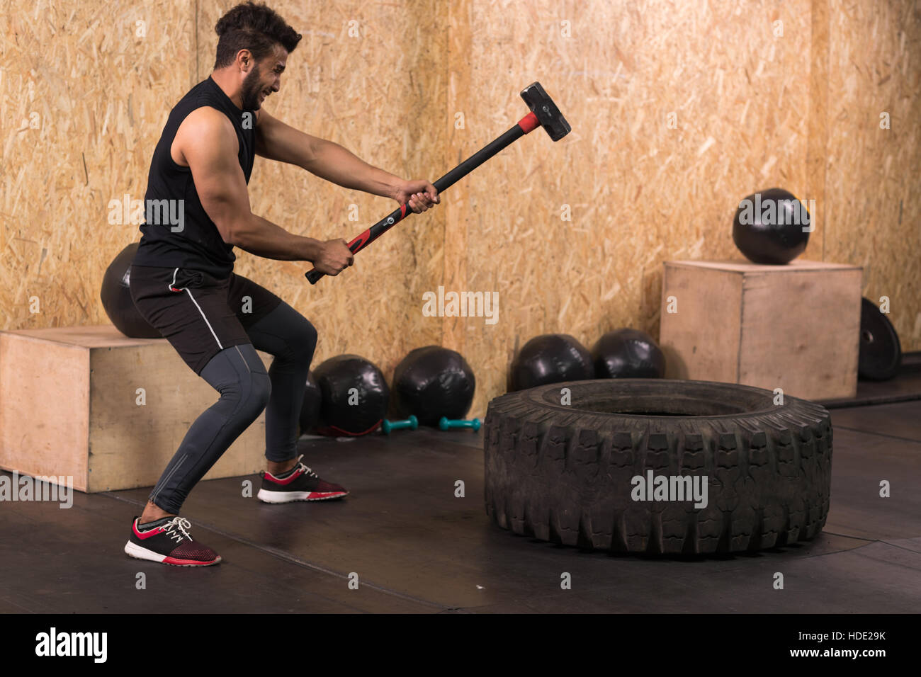 Crossfit sledge hammer man workout hires stock photography and images