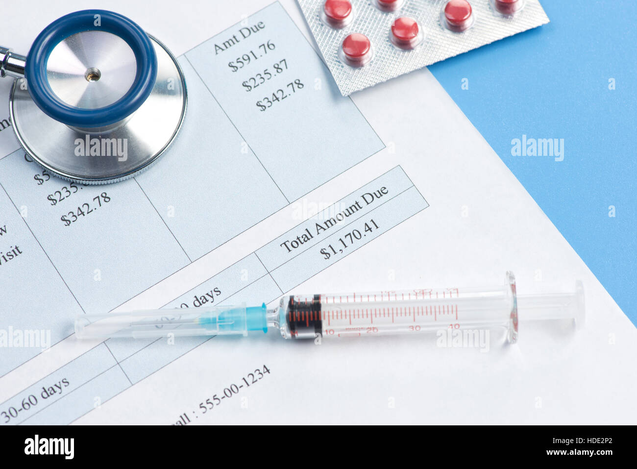 Hypothetical hospital bill with syringe and medication.  Document created by photographer. Stock Photo