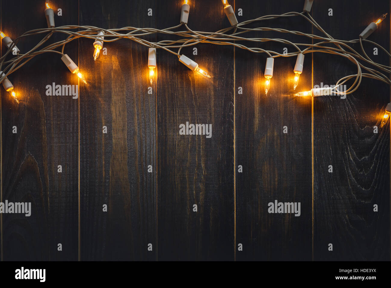 christmas background lights and copy space on old wooden board background Stock Photo