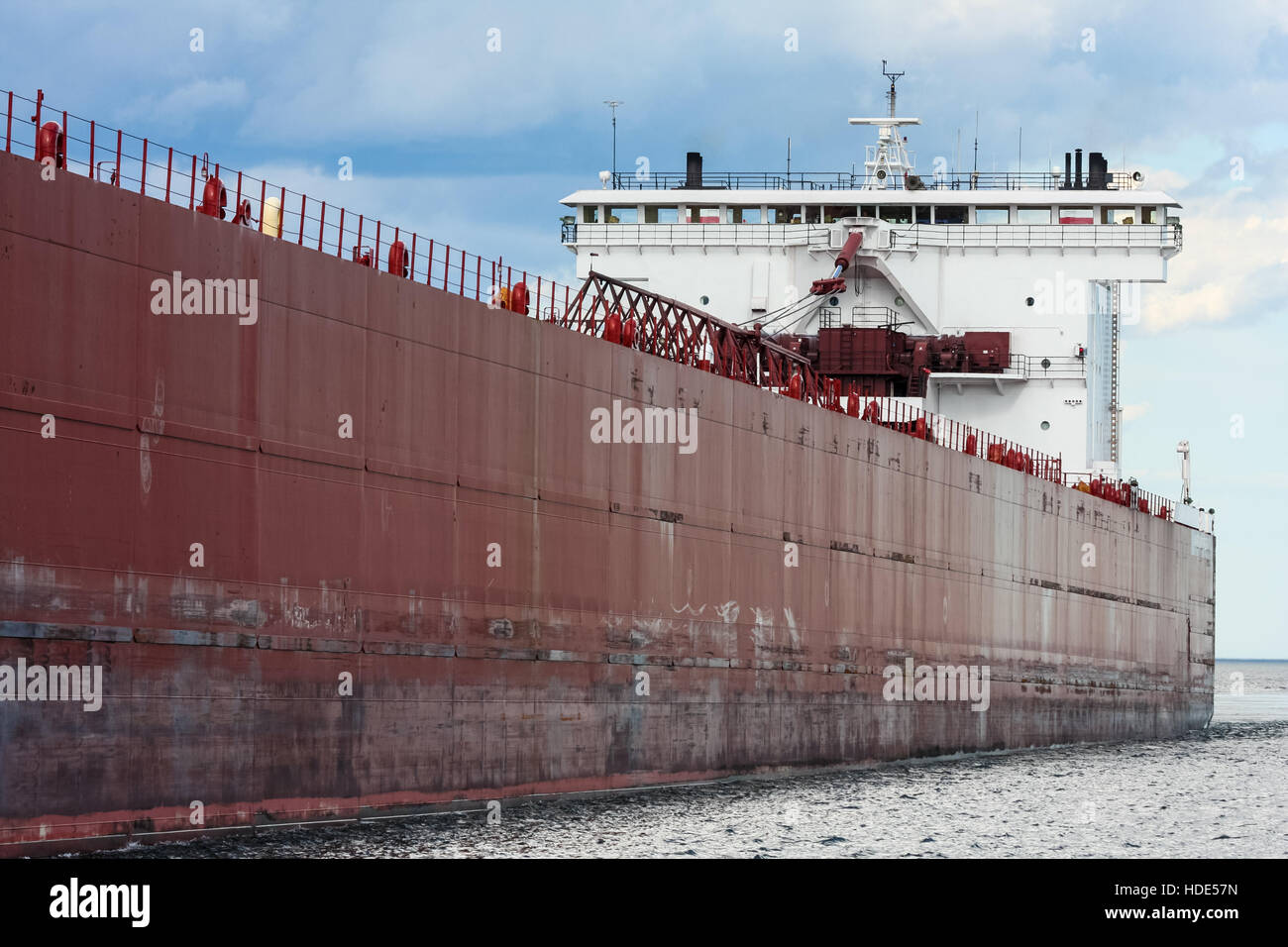 A huge lake freighter on Lake Superior enters the Duluth Ship Canal on a cloudy day. Stock Photo