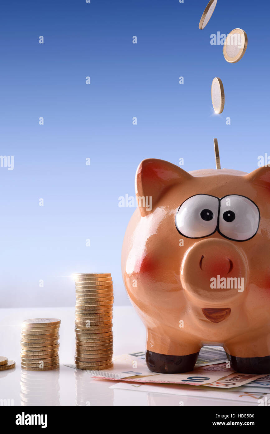 Concept savings with coins falling on piggy bank with savings billboard ...
