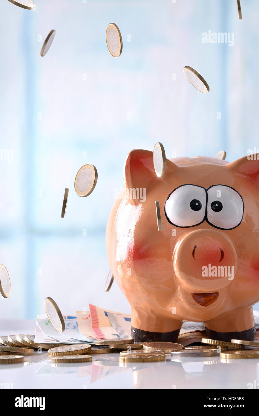 Concept savings with coins falling on piggy bank with savings billboard ...