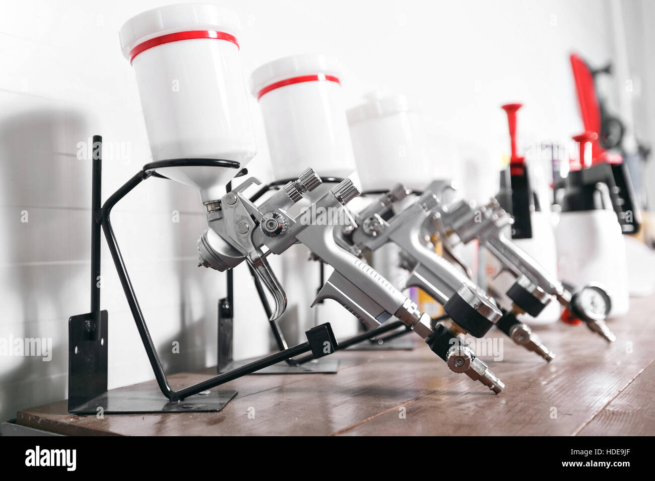 spray gun on wood table. in auto service. used for industrial painting