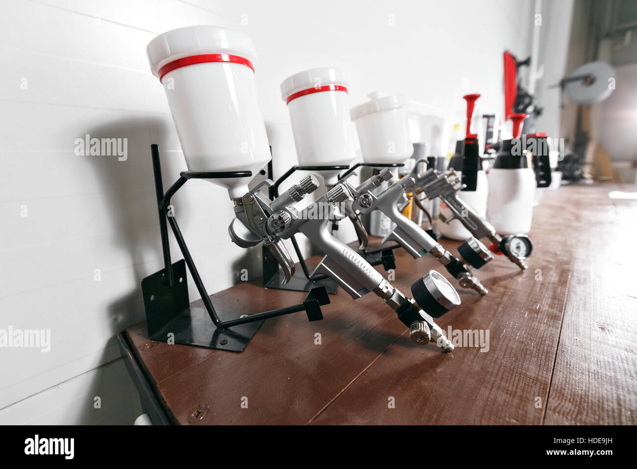 spray gun on wood table. in auto service. used for industrial painting