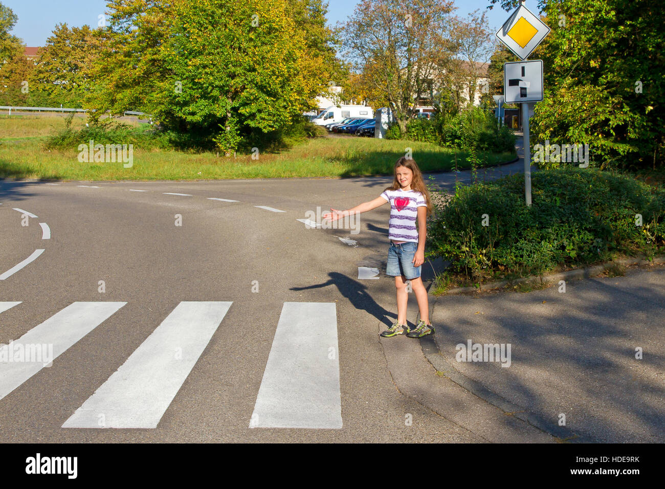 Young girl will go on the crosswalk Stock Photo