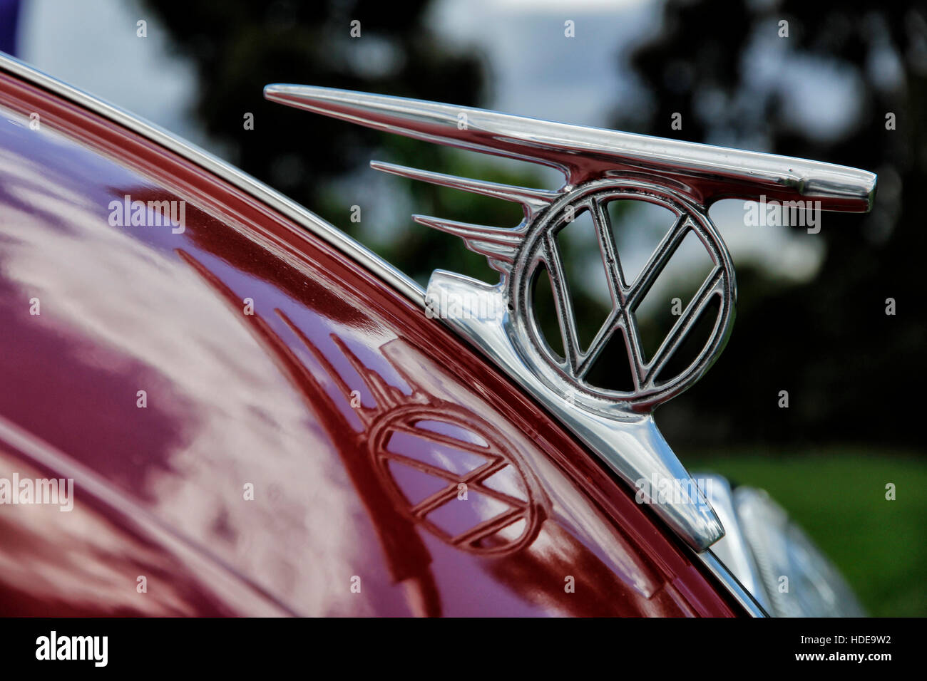 A classic Volkswagen symbol on a Beetle from 70's in red Stock Photo