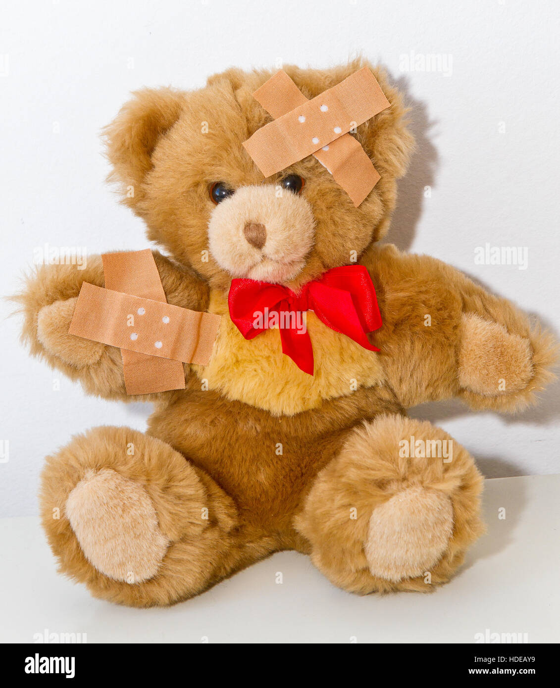 Teddy bear with plasters Stock Photo