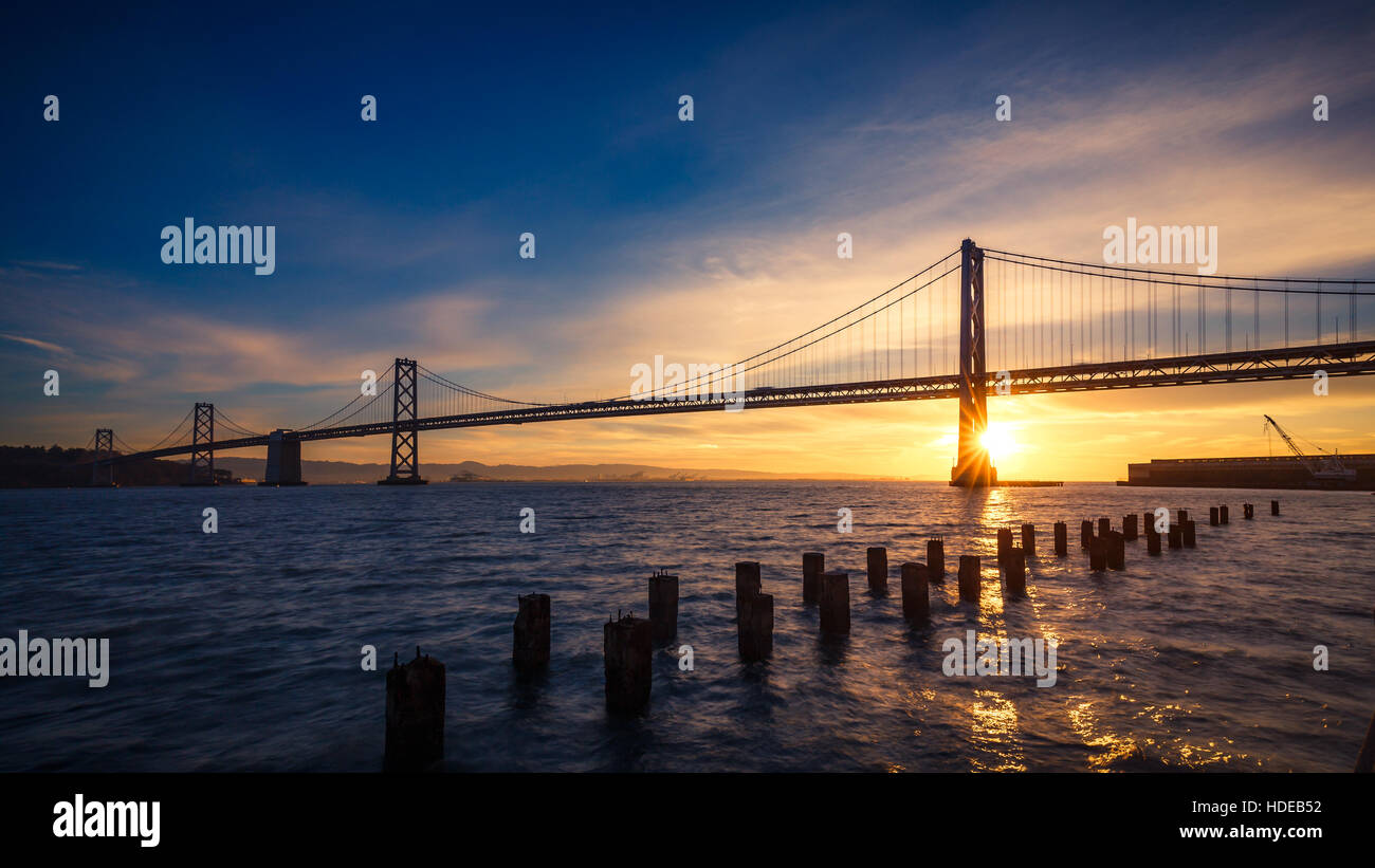 Sunrise at the SF-Oakland Bay Bridge with sun starburst, San Francisco, California Stock Photo