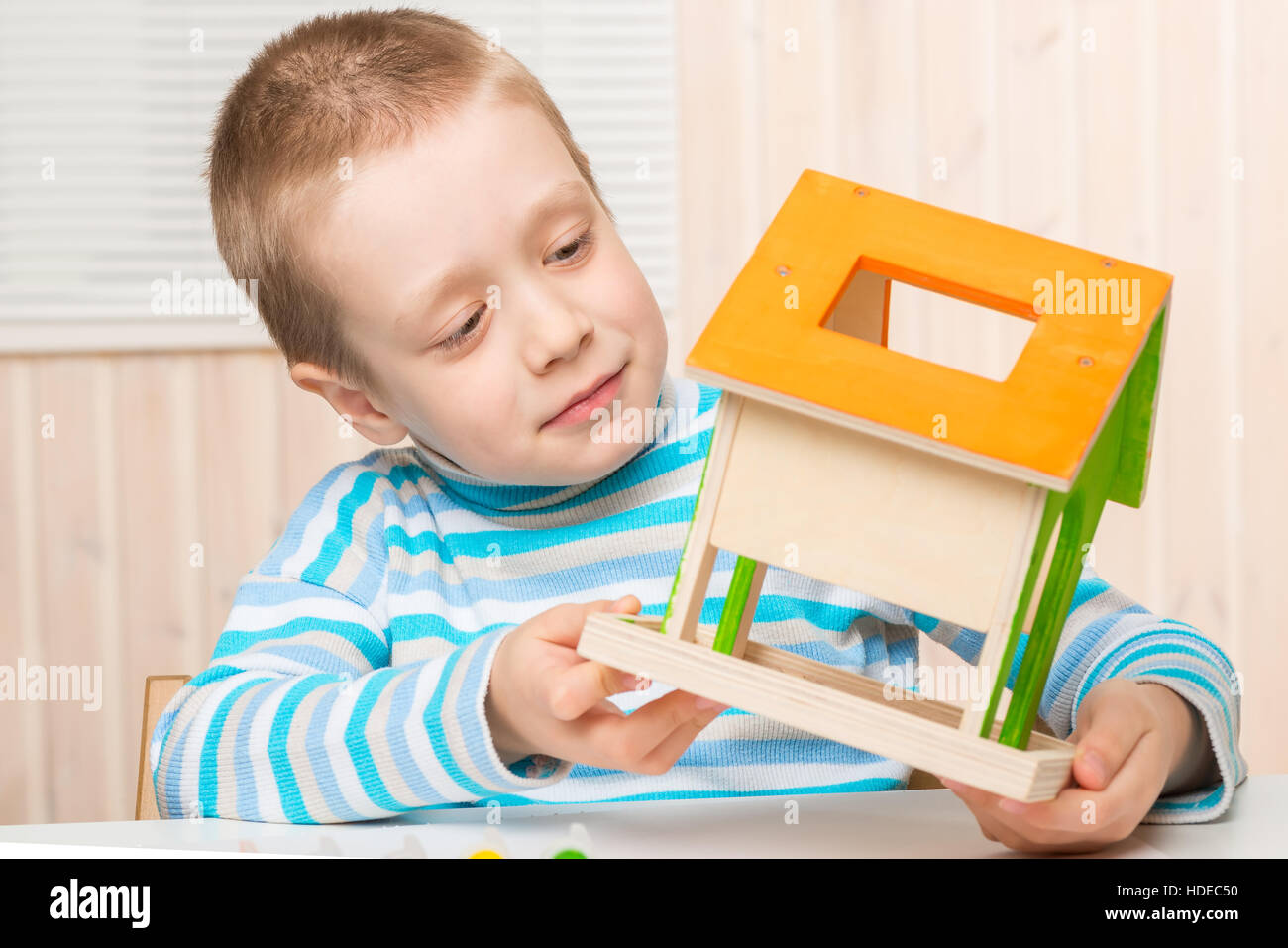 portrait of the boy of the preschool child with a feeding trough for birds handmade Stock Photo