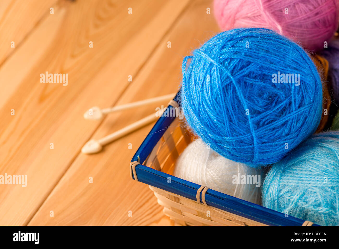 needlework still life - hand knitting tools and wool yarns on wooden table  Stock Photo - Alamy