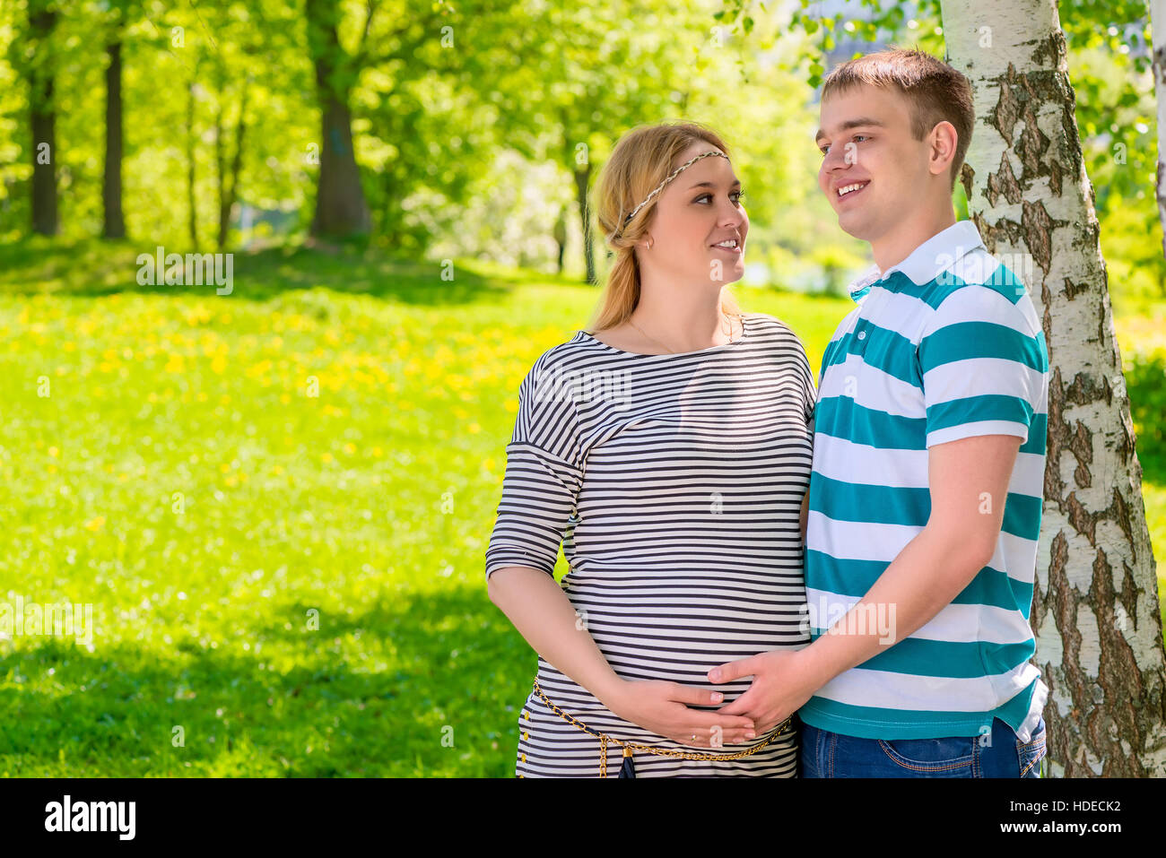 future parents couple posing in the summer park Stock Photo
