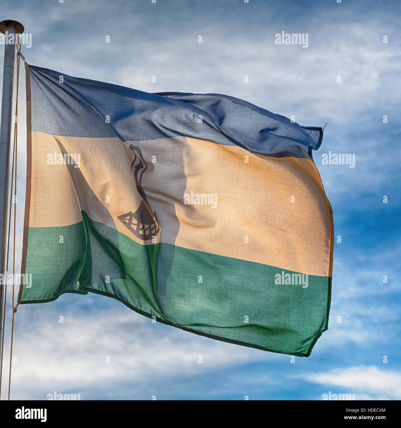 blur in lesotho waving national flag in the cloudy sky Stock Photo - Alamy