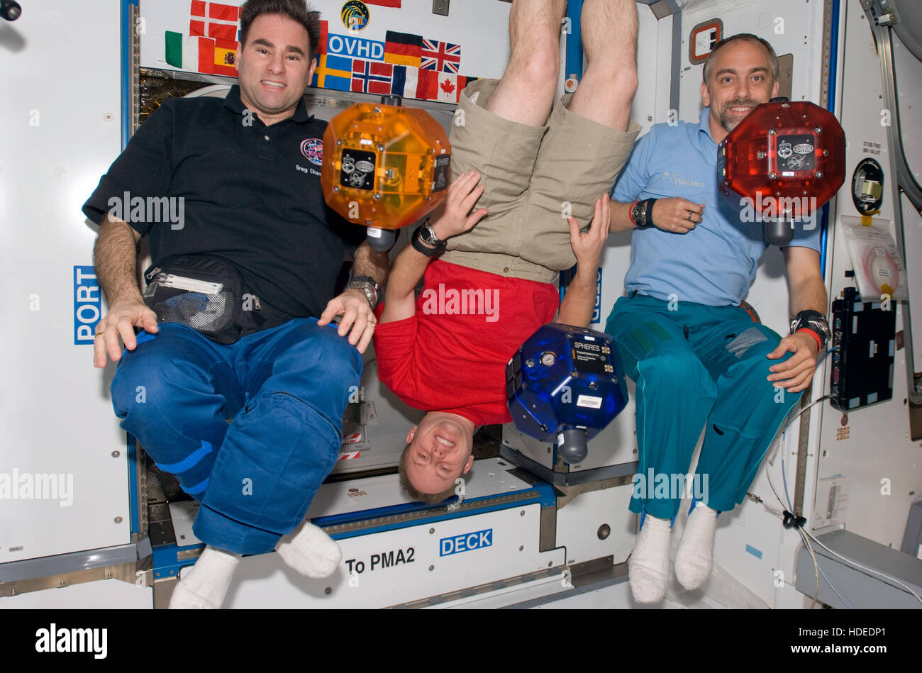 NASA International Space Station Expedition 18 astronauts (L-R) Gregory Chamitoff, Michael Fincke, and spaceflight participant British video game developer Richard Garriott float in the Harmony node of the ISS with Synchronized Position Hold, Engage, Reorient, Experimental Satellites October 22, 2008 in Earth orbit. Stock Photo