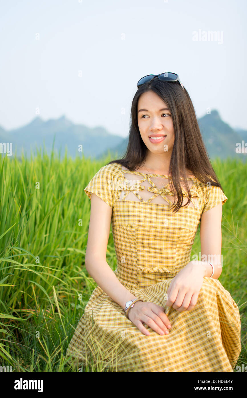 Happy girl in the rice field with karst scenery Stock Photo
