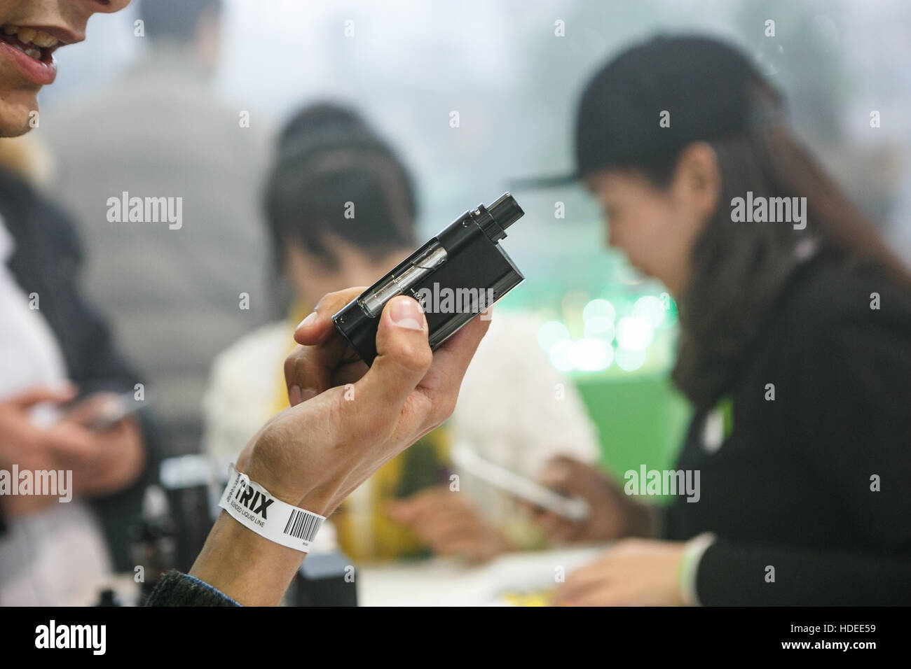 MOSCOW - 9 DECEMBER,2016: International Vape Expo.Man try new vaper ejuice liquid and vapind device gadget Stock Photo