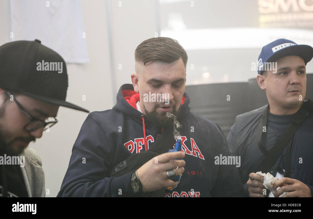MOSCOW - 9 DECEMBER,2016: International Vape Expo.Russian rap star,famous rapper singer Basta try new vaping device and vaper liquid ejuice. Stock Photo