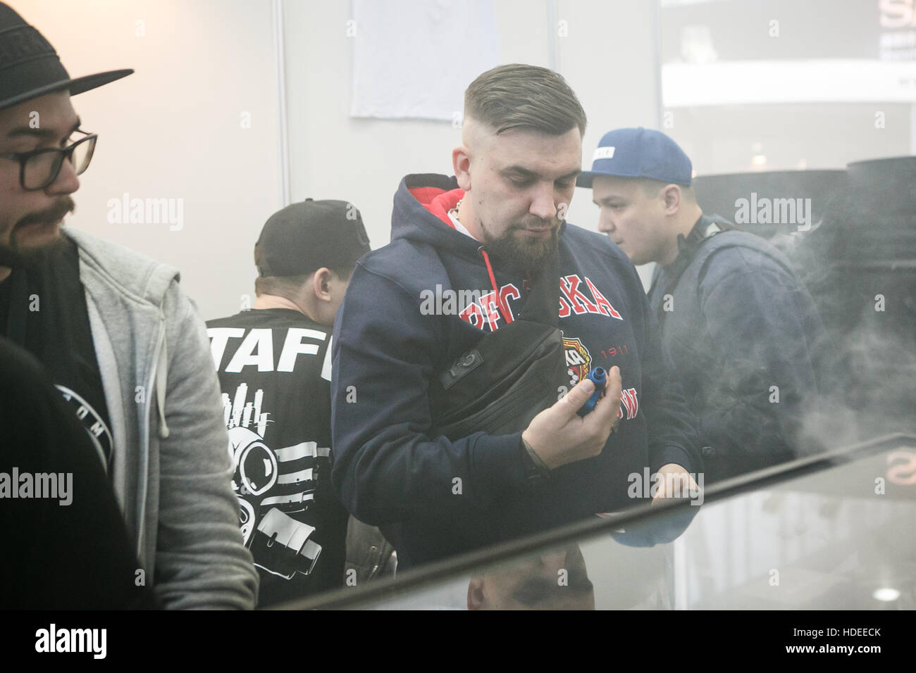 MOSCOW - 9 DECEMBER,2016: International Vape Expo.Russian rap star,famous rapper singer Basta try new vaping device and vaper liquid ejuice. Stock Photo