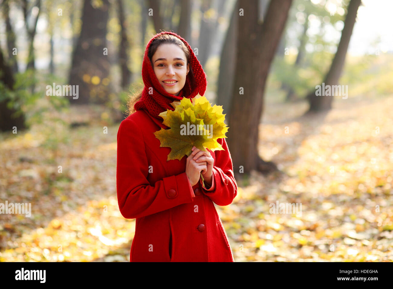 Beautiful young girl walking in autumn park Stock Photo - Alamy