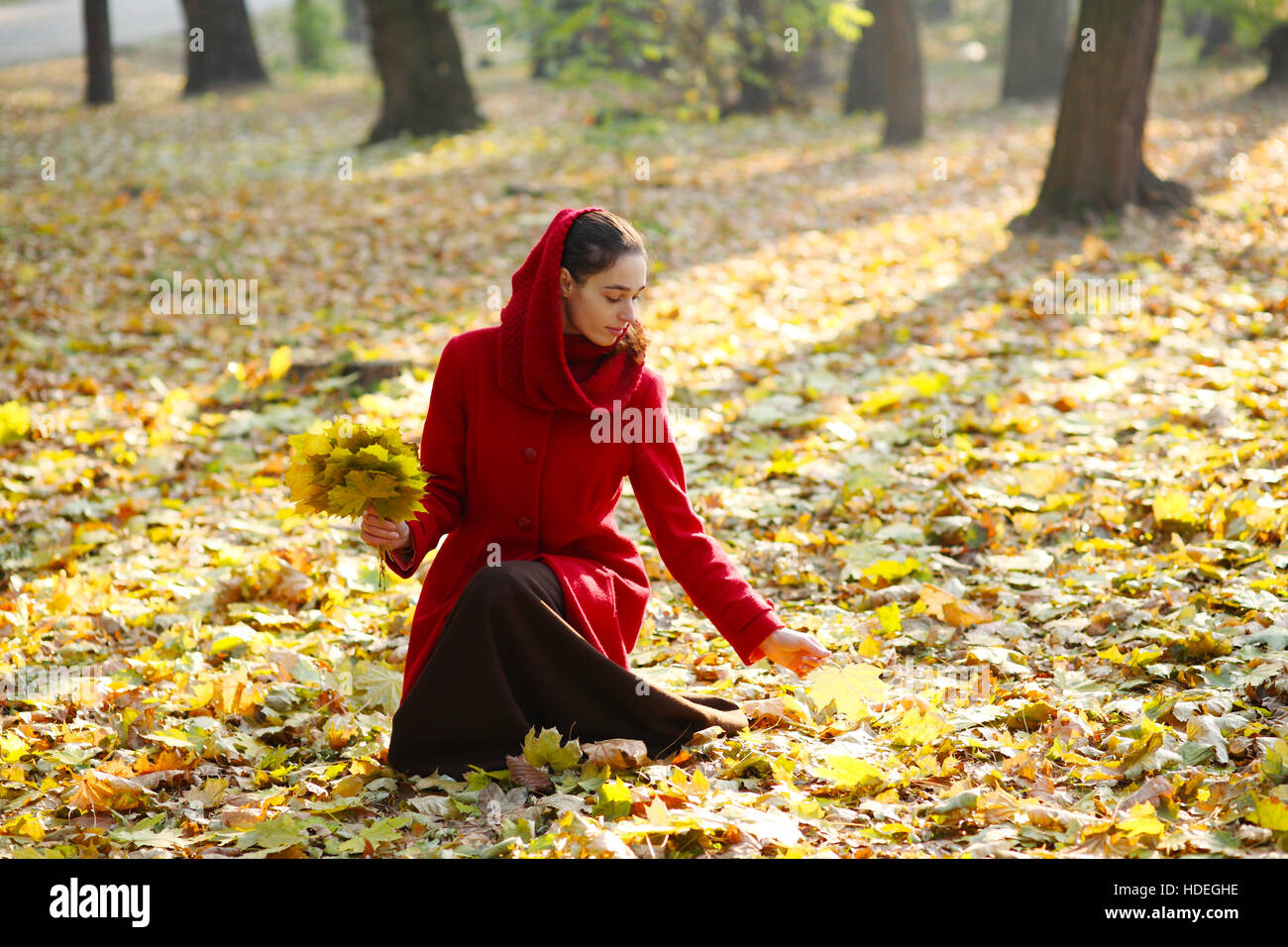 Beautiful young girl walking in autumn park Stock Photo - Alamy