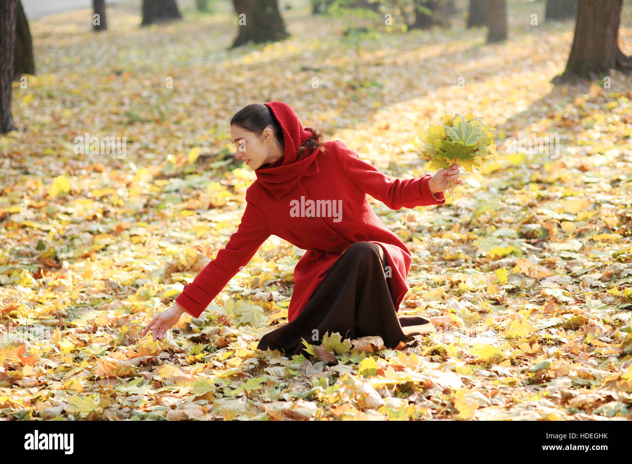 Beautiful young girl walking in autumn park Stock Photo - Alamy
