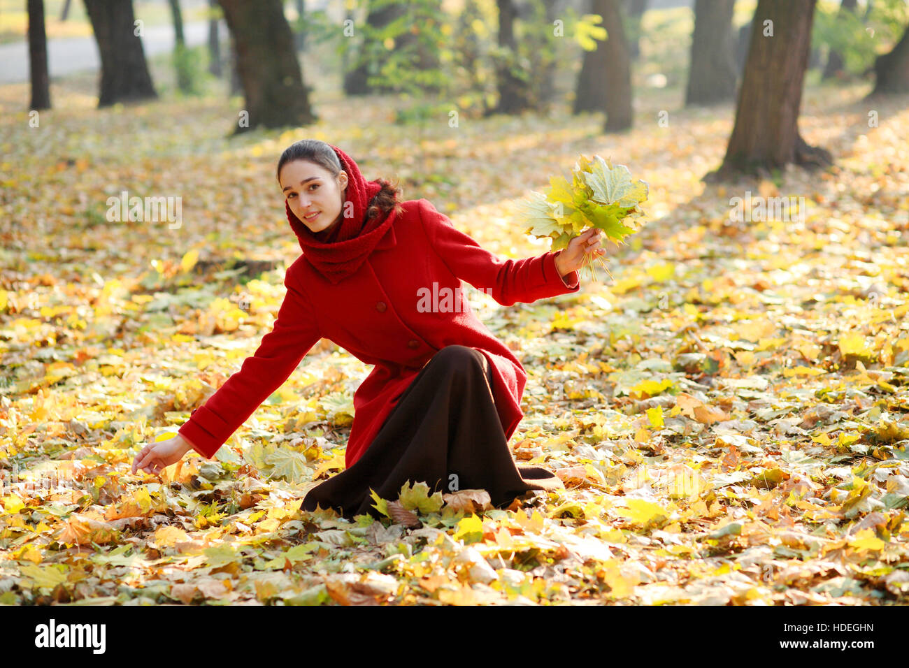 Beautiful young girl walking in autumn park Stock Photo - Alamy