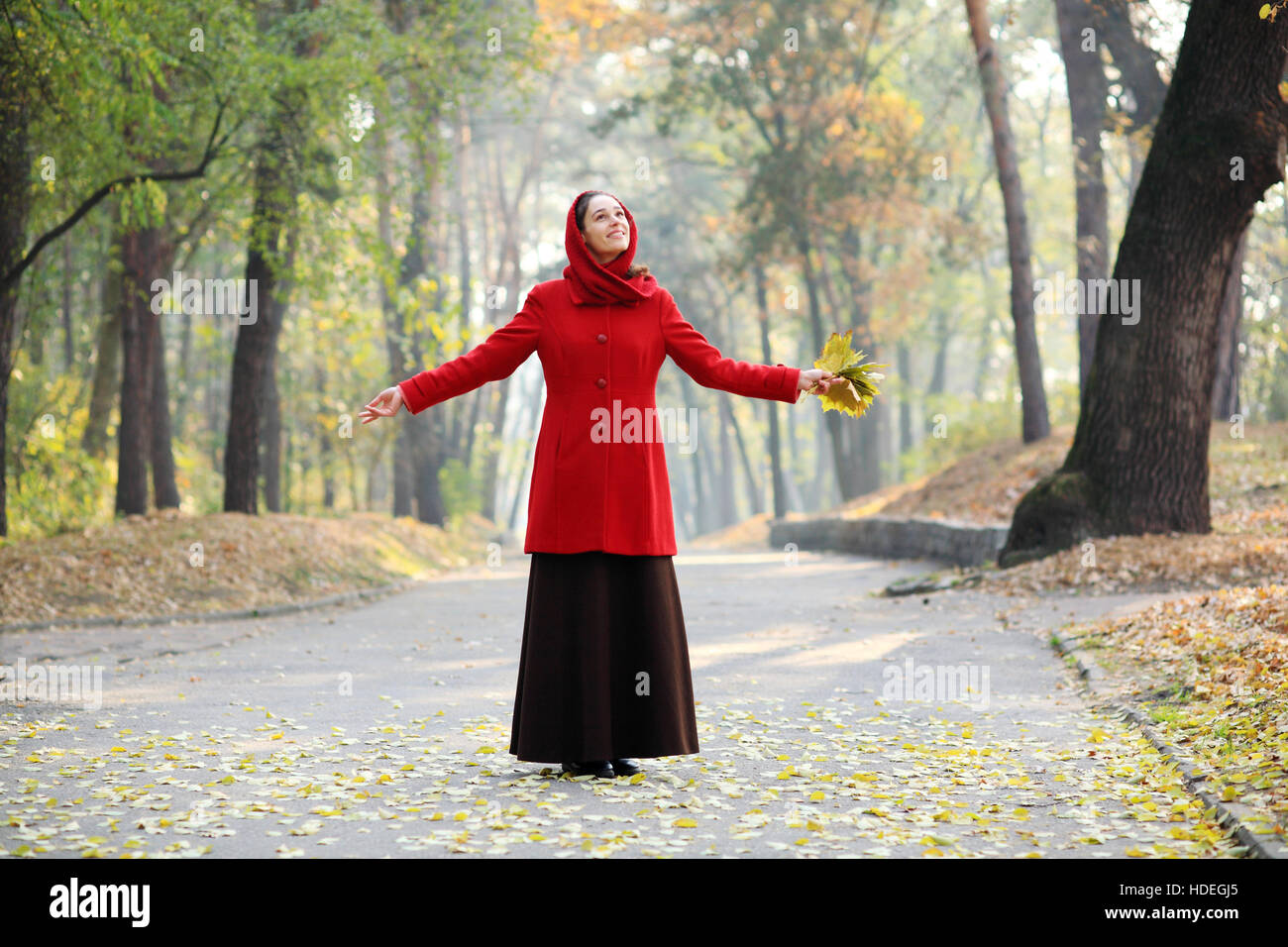 Beautiful young girl walking in autumn park Stock Photo - Alamy