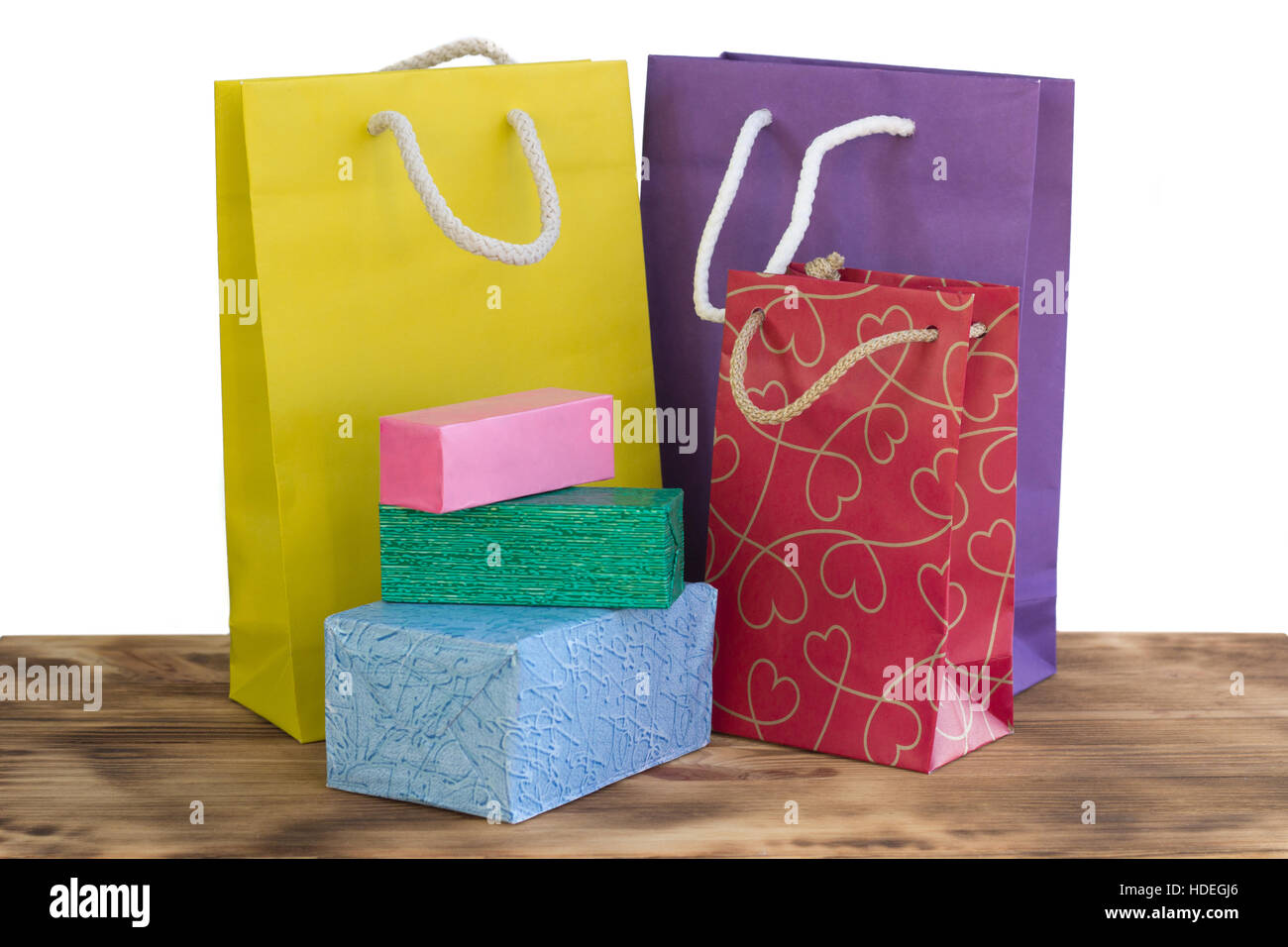 Colourful and bright shopping packages and boxes for gifts and presents on wooden table Stock Photo