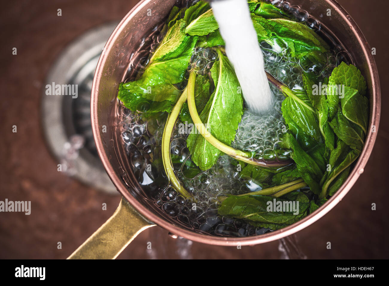 Washing the mint in the colander Stock Photo