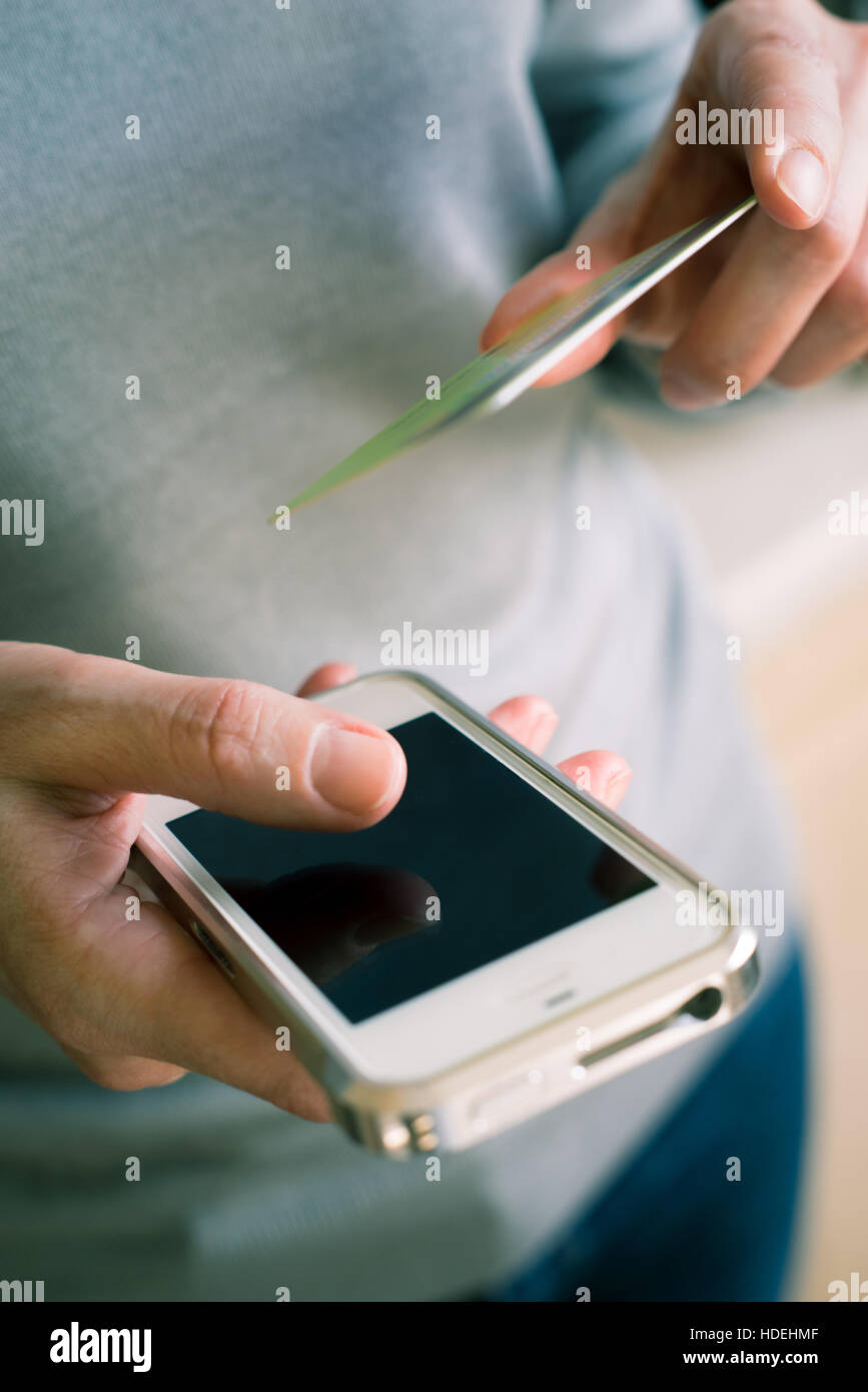 Woman with credit card ant mobile phone in the hand Stock Photo