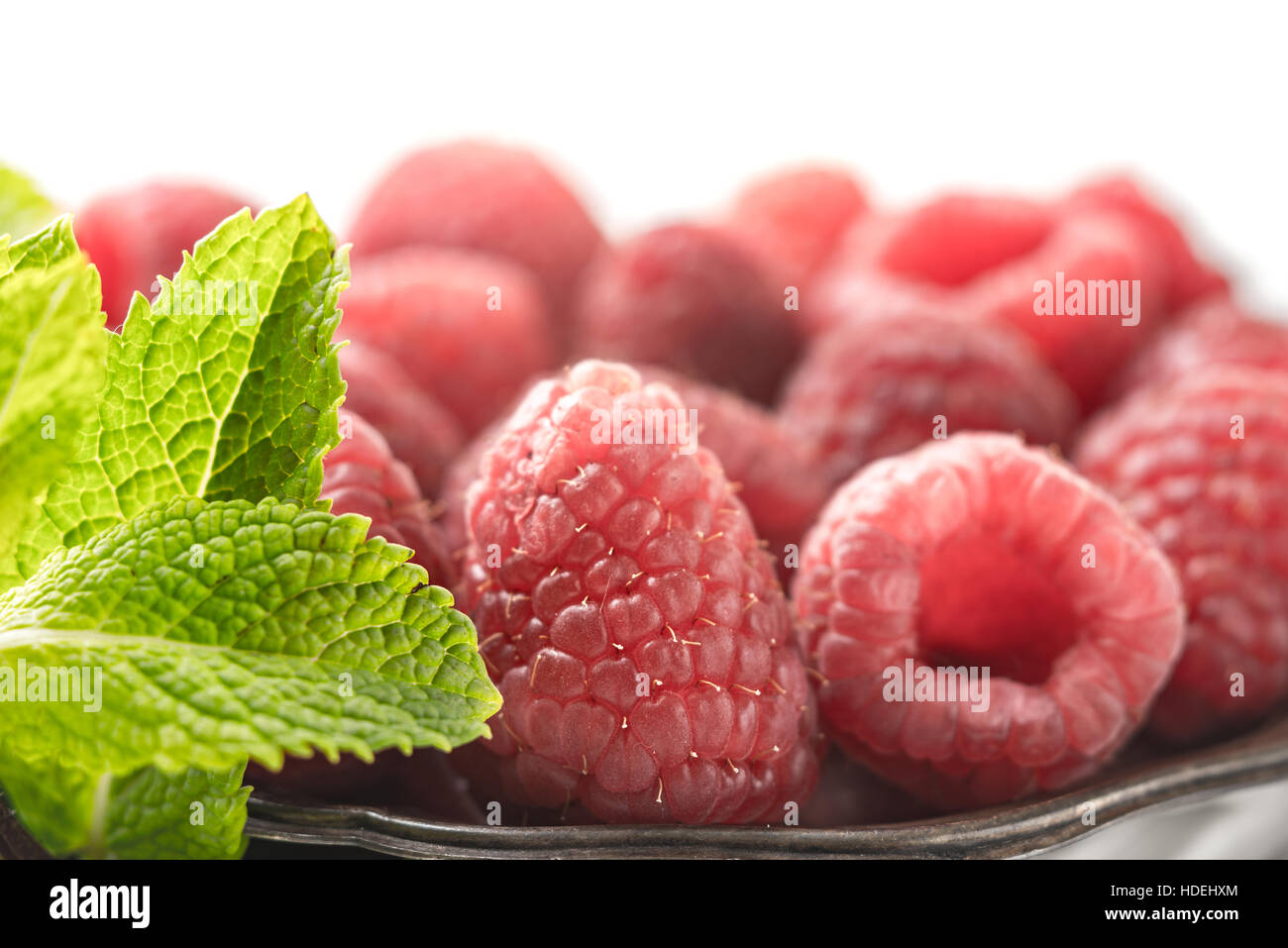 Raspberries with mint on the metal plate Stock Photo