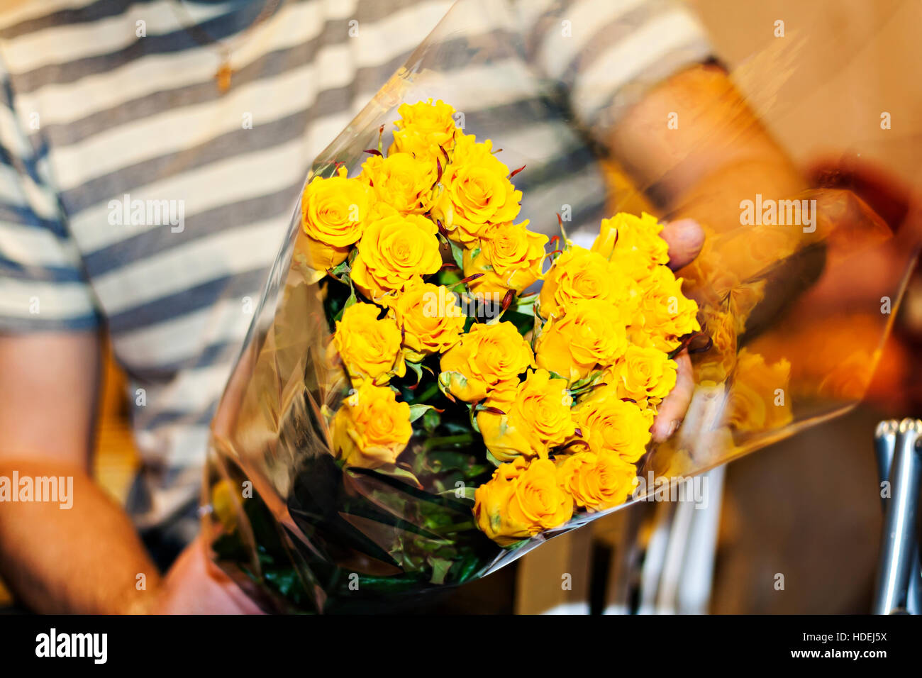 man holding a large bouquet of yellow roses Stock Photo - Alamy