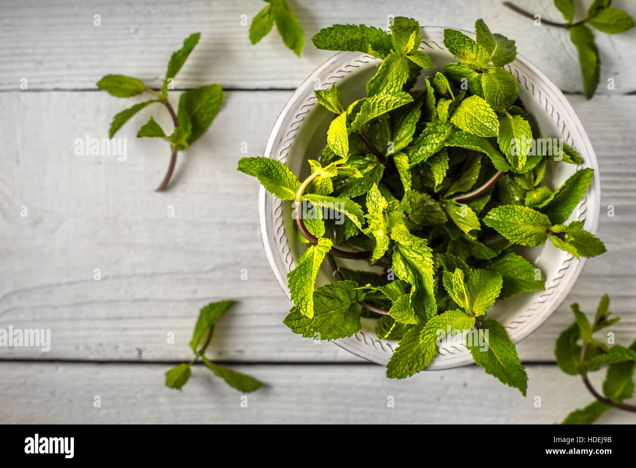 Composition of the mint leaves on the white wooden table top view Stock Photo