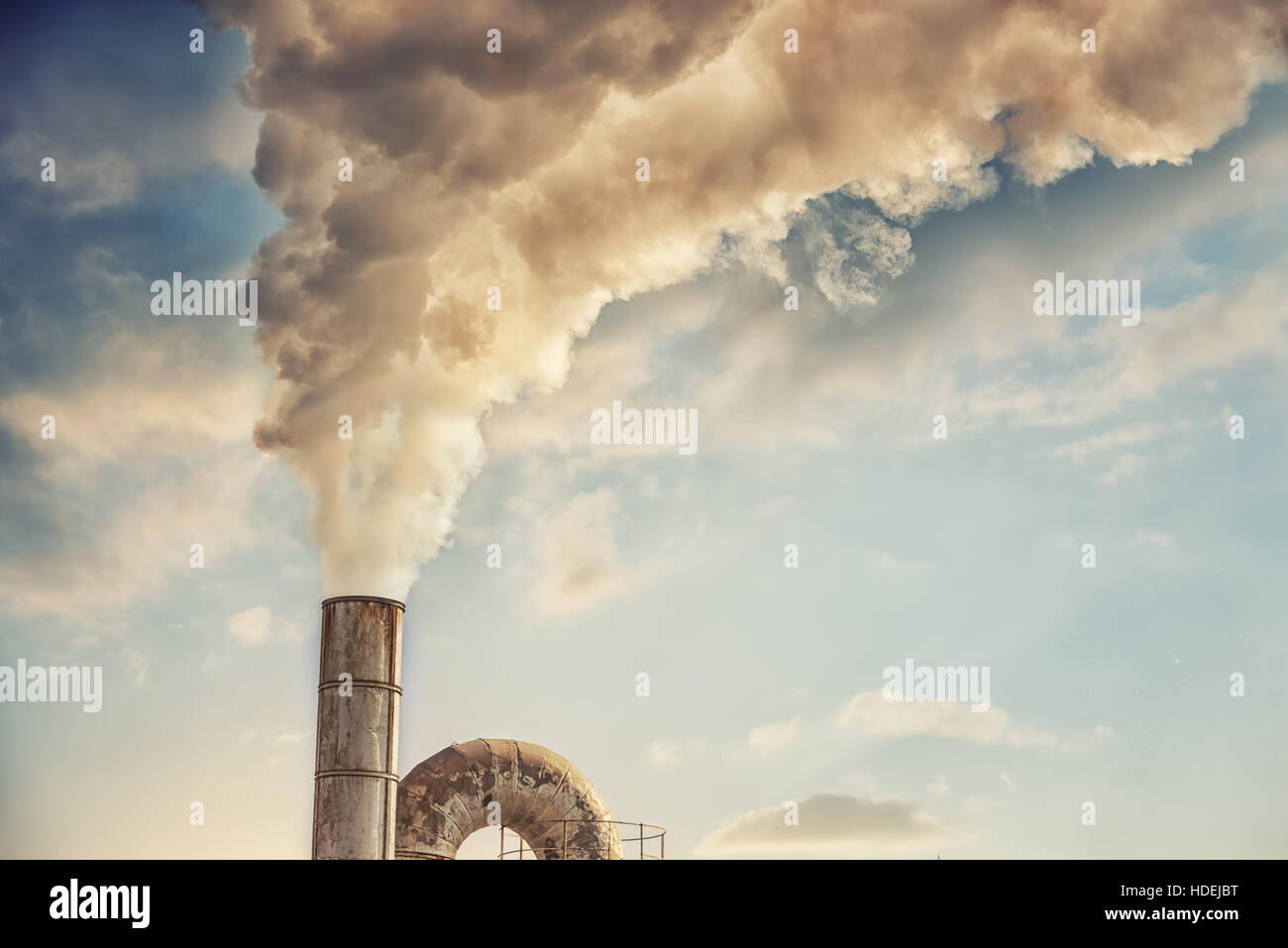 industrial smoke from chimney on blue sky Stock Photo