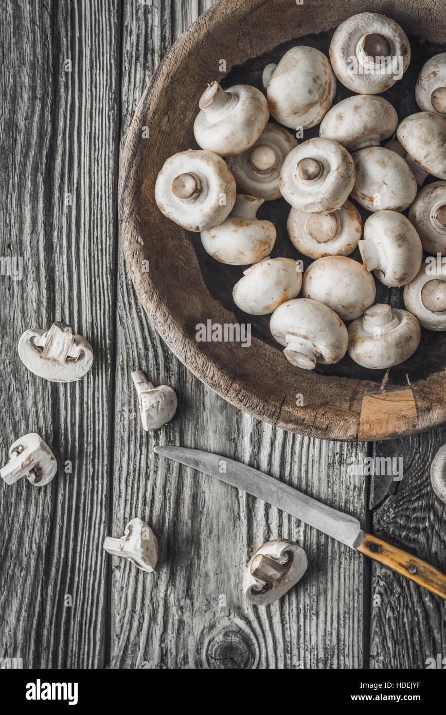 Champignon on the wooden bowl on the old table horizontal Stock Photo