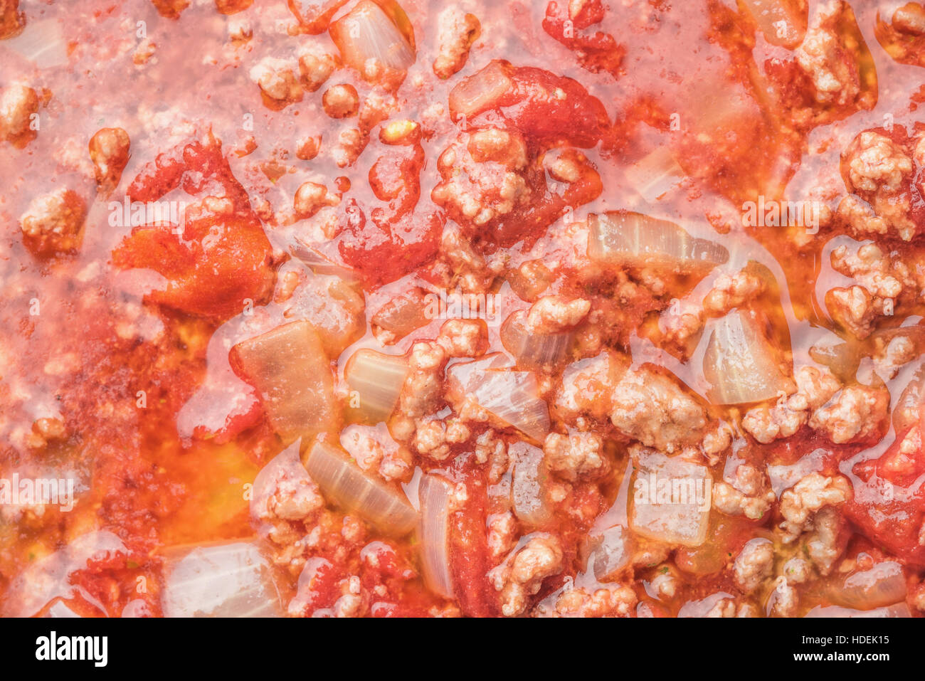 Stew meat with onion and tomatoes background closeup Stock Photo Alamy